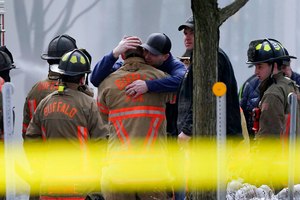 Buffalo firefighters comforted each other Wednesday while waiting for a chance to recover the body of Jason Arno, who went missing during a massive blaze at 745 Main Street, in Buffalo, N.Y.