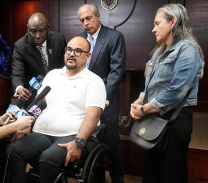 Michael Ortiz speaks at a news conference regarding a lawsuit against a police officer.
