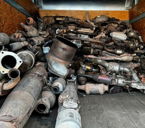 This photo provided by the Phoenix Police Department shows stolen catalytic converters that were recovered after detectives served a search warrant at a storage unit.