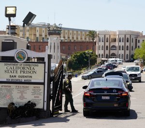 A CO checks vehicles entering the main gate at San Quentin State Prison.