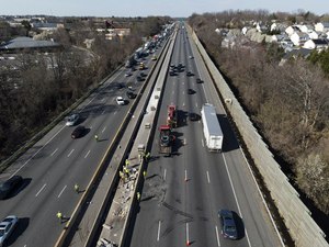 First responders work at the scene of a fatal crash on Interstate 695 on Wednesday near Woodlawn, Maryland. People were killed when a passenger vehicle pulled into a work zone along the beltway and struck construction workers there, Maryland State Police said.