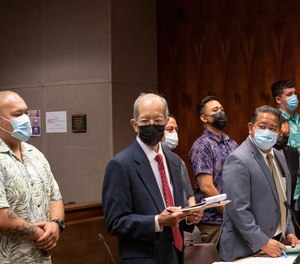 Honolulu Police Department police officers, back row left to right, Joshua Nahulu, Robert G. Lewis III, Jake R.T. Bartolome and Erik X.K. Smith make their initial court appearance.