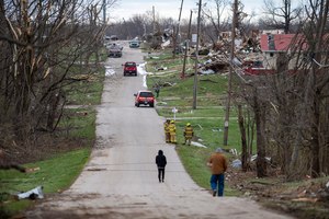 Damage from a late-night tornado is seen in Sullivan, Indiana on Saturday. Firefighters were on the scene.