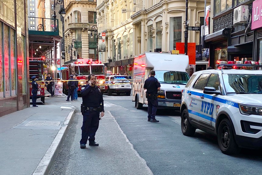 New York City police officers and firefighters cordoned off part of New York's Financial District on Tuesday afternoon near the site of a partially collapsed parking garage.