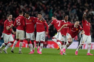 Manchester United players celebrate after winning the English FA Cup semifinal soccer match Sunday.