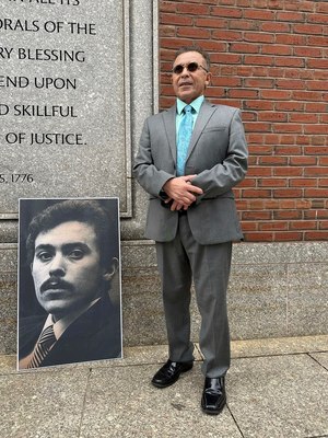 Victor Rosario, 65, stands next to a photo of himself at age 24 when he was on trial in 1982 for arson, on May 3, 2023, outside the federal courthouse in Boston.