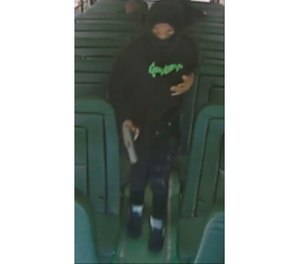 This image taken from Prince George's County Police Department twitter page shows a person with a gun on Monday, May 1, 2023 in Oxon Hill, Md. Police in Maryland say three masked attackers boarded a school bus earlier this week and one tried to shoot a student but the gun malfunctioned.