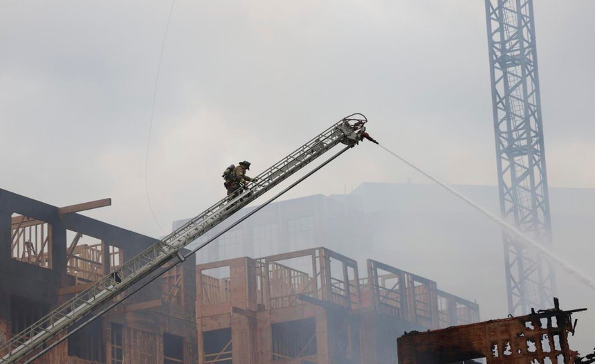 Firefighters climbed the crane and protected the operator as they all climbed back down the crane together.
