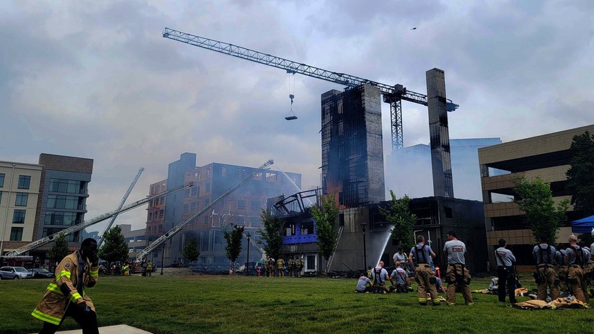 Firefighters work the scene of a massive fire spread across at least two structures and threatened others in Charlotte's South Park neighborhood.