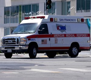 An American Medical Response vehicle drives in San Francisco, Monday, May 22, 2023. Lawyers sued medical transport provider American Medical Response West, saying the ambulance company's lax oversight allowed a paramedic to sexually assault two women in their 80s on their way to a hospital.