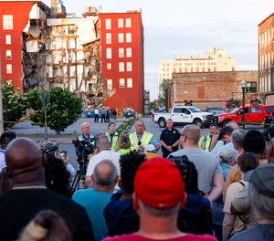 Officials update media, residents and onlookers after a partial building collapse on the 300 block of Main Street, Sunday, May 28, 2023, in Davenport, Iowa.