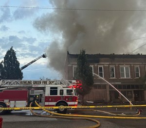 Members of the Bowling Green Fire Department work to extinguish an early morning structure fire on State Street.