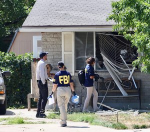 Law enforcement investigate the scene of a shooting involving the FBI Wednesday, Aug. 9, 2023 in Provo, Utah.
