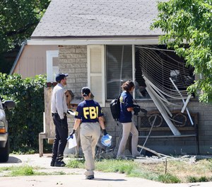 Law enforcement investigate the scene of a shooting involving the FBI Wednesday, Aug. 9, 2023 in Provo, Utah.