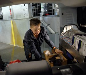 WellPower clinician Jane Lemaux loads supplies into a STAR van in Denver on Thursday, Oct. 20, 2022. The STAR program uses clinicians and EMTs or paramedics to respond to nonviolent mental health crises, instead of police.
