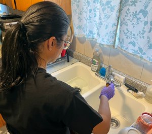 Purdue University graduate student Paula Coelho collects drinking water samples at a home in Kula, Hawaii, on Aug. 20, 2023. A team from Purdue helped the University of Hawaii at Mānoa conduct free sampling in peoples' homes who were issued an 