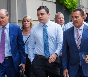 Philadelphia police officer Mark Dial, center, arrives at the Juanita Kidd Stout Center for Criminal Justice in Philadelphia, Tuesday, Sept. 19, 2023, with attorneys for a bail hearing.