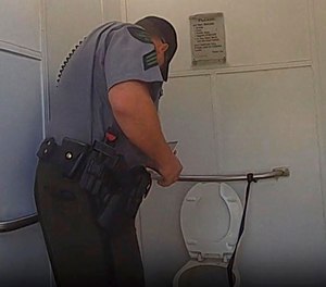 The woman, whose name was not released, lowered herself inside the toilet after dropping the watch.