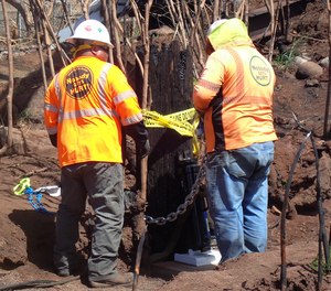 In this photo provided by the Morgan & Morgan law firm, utility contractors remove a charred Hawaiian Electric utility pole stump in Lahaina, Maui, Hawaii on Aug. 29, 2023. Investigators are examining this and other pieces of evidence as they seek to solve the mystery of how a small, wind-whipped fire sparked by downed power lines and declared extinguished flare up again hours later into a devastating inferno.