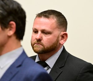 Aurora Police officer Randy Roedema, right, attends an arraignment at the Adams County Justice Center in Brighton, Colo., Friday, Jan. 20, 2023.