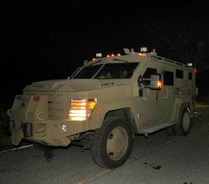 Law enforcement officers depart a scene in an armored vehicle after investigating a location, in Bowdoin, Maine, Thursday, Oct. 26, 2023.