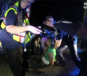 This image from video from Auckland state trooper Lt. John Clary's body-worn camera shows troopers and medical personnel with Ronald Greene on May 10, 2019, outside of Monroe, La.