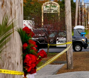 Crime scene tape still surrounds Schemengees Bar & Grille as a Lewiston Police Hazmat officer blocks the entrance, Oct. 29, 2023, in Lewiston, Maine.