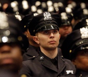 Department of Correction graduating officers participate in the Promotion and Recruit Graduation Ceremony, Friday, Feb. 13, 2015, in the Bronx borough of New York.