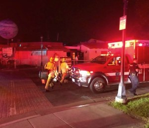 Emergency personnel respond to utility pole explosions where multiple people were injured at the Old World Village on Saturday, Oct. 5, 2019, in Huntington Beach, Calif. (Emily Rasmussen/The Orange County Register/SCNG via AP)