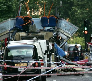 In this file photo dated July 7, 2005, the wreckage of a double-decker London bus with its top blown off and damaged cars scattered on the road at Tavistock Square in central London.