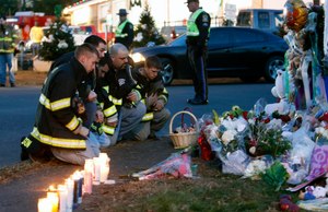 Firefighters pay their respects at a memorial for shooting victims near Sandy Hook Elementary School, Saturday, Dec. 15, 2012 in Newtown, Conn.