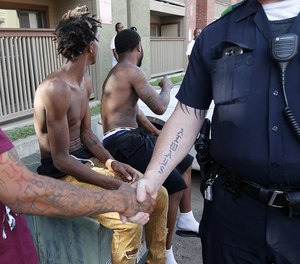 A Dallas police officer says goodbye to residents while performing community patrol. On each and every call and with each new contact, officers are shaping the way the public views the profession as a whole.