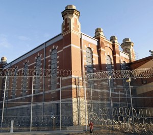 This Dec. 22, 2006 file photo shows a barbed wire fence surrounding a cell house at the North Dakota State Penitentiary in Bismarck.