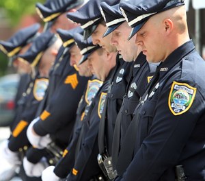Police officers from the Brentwood, N.H. police department listen  to a prayer during an annual ceremony to honor law enforcement officers who died in the line of duty.