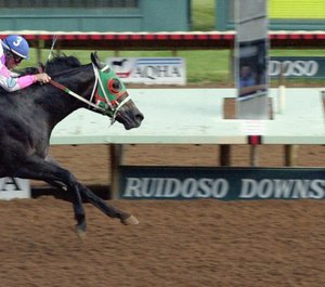 An EMT employed at Ruidoso Downs Race Track says he was asked to remove a thin red line flag, thin blue line flag and half-U.S., half-Confederate flag from his vehicle by the general manager. (AP Photo/Jake Schoellkopf)