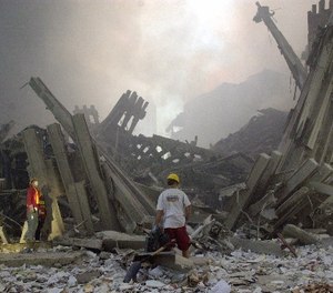Destroyed mullions, the vertical struts which once faced the soaring outer walls of the World Trade Center towers, are examined by emergency workers, after a terrorist attack on the twin towers of lower Manhattan Tuesday, Sept. 11, 2001.