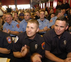 Graduates applaud at The Massachusetts Firefighting Academy as Recruit Class #151, graduates Friday, June 21, 2002, in Stowe, Mass.