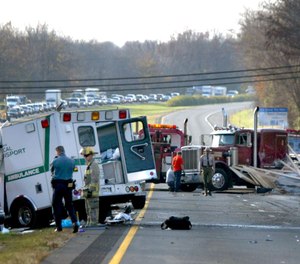 Howard County police and rescue workers examine the scene of a fatal accident Thursday, Nov. 18, 2004, on westbound Interstate 70 at U.S. 29 in Ellicott City, Md.