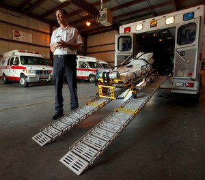 In this photo taken Aug. 7, 2009, American Medical Response operations manager Ken Keller talks about the specially-equipped ambulance used for obese patients at the company's Topeka, Kan. facility.