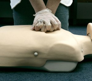 In this Sept. 15, 2006 file photo, a person participates in an American Red Cross CPR training in Washington. A team of researchers and physicians have created a method to improve cardiac arrest outcomes through a clinical analysis of recorded CPR cases.