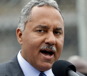 New Orleans Sheriff Marlin Gusman speaks to reporters at a news conference outside the construction site of new jail facilities in New Orleans, Thursday, April 4, 2013. (AP Photo/Gerald Herbert)