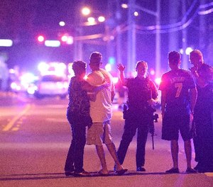 Orlando Police officers direct family members away from a fatal shooting at Pulse Orlando nightclub in Orlando, Fla., Sunday, June 12, 2016.