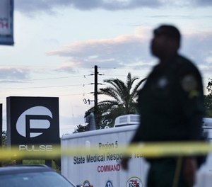 A police officer walks by a road closure outside the Pulse nightclub following the Sunday, June 19, 2016, in Orlando, Fla.