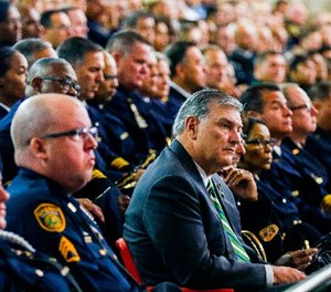 Dallas Mayor Mike Rawlings is surrounded by police officers during a funeral service for Dallas police officer Patrick Zamarripa on Saturday, July 16, 2016, at Wilkerson-Greines Athletic Center in Fort Worth, Texas. (Ashley Landis /The Dallas Morning News via AP, Pool)