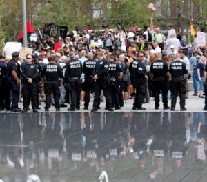 Police officers stand guard in Public Square during a protest on Thursday, July 21, 2016, in Cleveland, during the final day of the Republican convention.