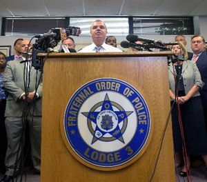 Gene Ryan, center, president of the Baltimore Fraternal Order of Police, speaks during a news conference in Baltimore, Wednesday, July 27, 2016.
