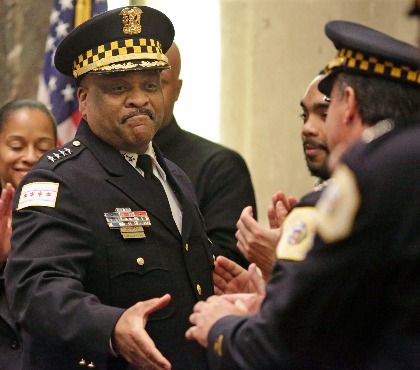 In this April 13, 2016 file photo, Chicago's police superintendent Eddie Johnson, left, shakes hands with other officers at a city council meeting in Chicago.