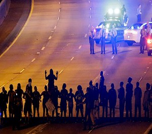 Protesters block I-277 during a third night of unrest following Tuesday's police shooting of Keith Lamont Scott in Charlotte, N.C., Thursday, Sept. 22, 2016.
