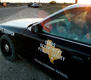 In this April 6, 2008, file photo, a Texas State Trooper is shown sitting in his vehicle in Eldorado, Texas.