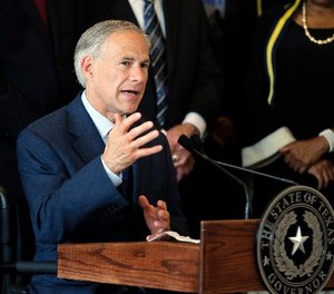 In this Friday, July 8, 2016 file photo, Texas Gov. Greg Abbott, right, responds to questions during a news conference at City Hall in Dallas.